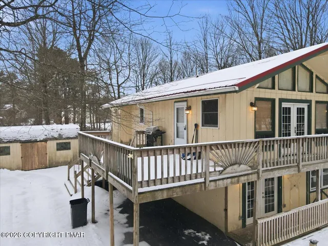 a view of a house with snow on the wall