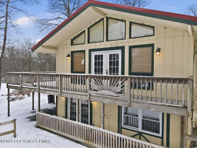 a view of house with a yard covered in snow