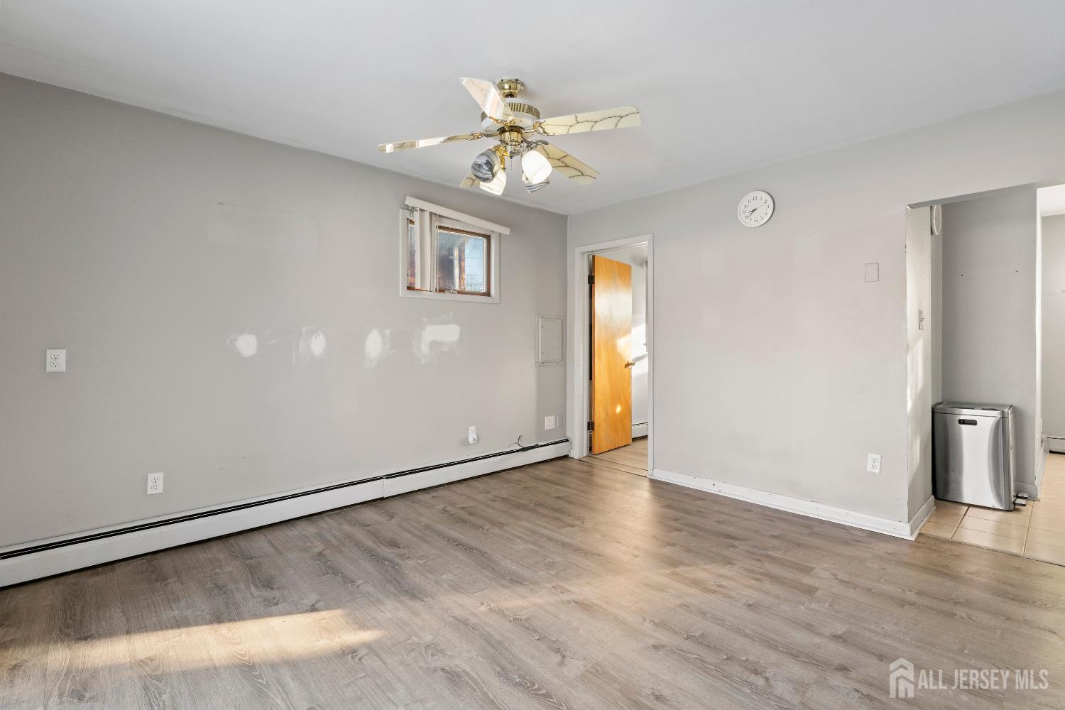 70 Central Avenue Sewaren, NJ 07064 - Photo 12 of 22 a view of an empty room with a ceiling fan and a window