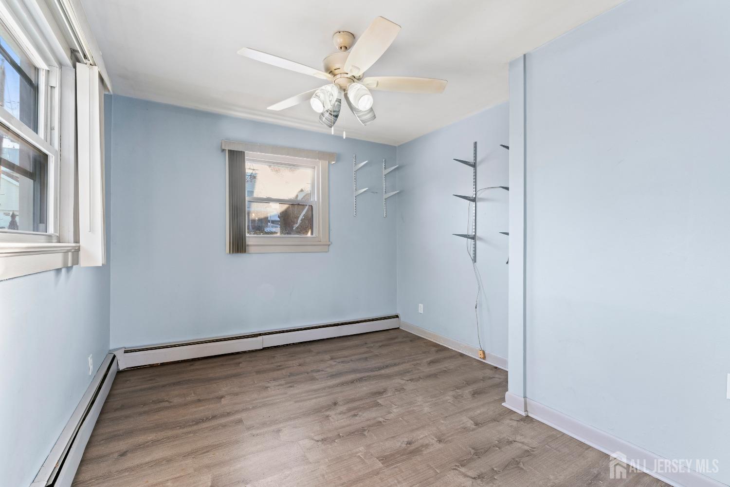 70 Central Avenue Sewaren, NJ 07064 - Photo 13 of 22 wooden floor in an empty room with a window
