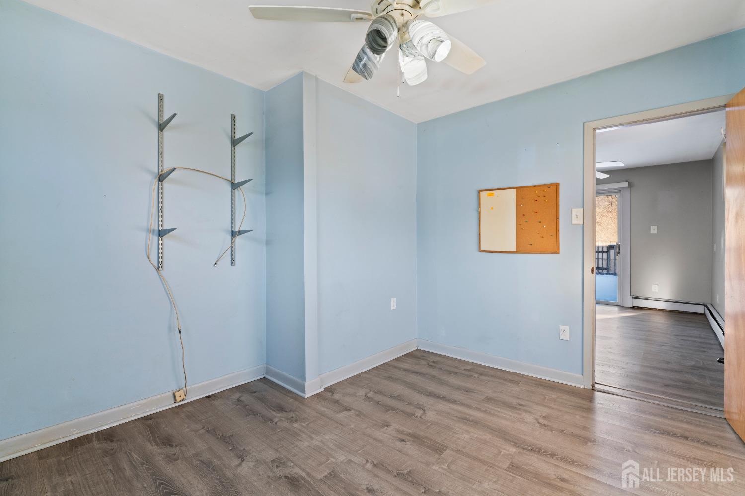70 Central Avenue Sewaren, NJ 07064 - Photo 14 of 22 an empty room with wooden floor and ceiling fan