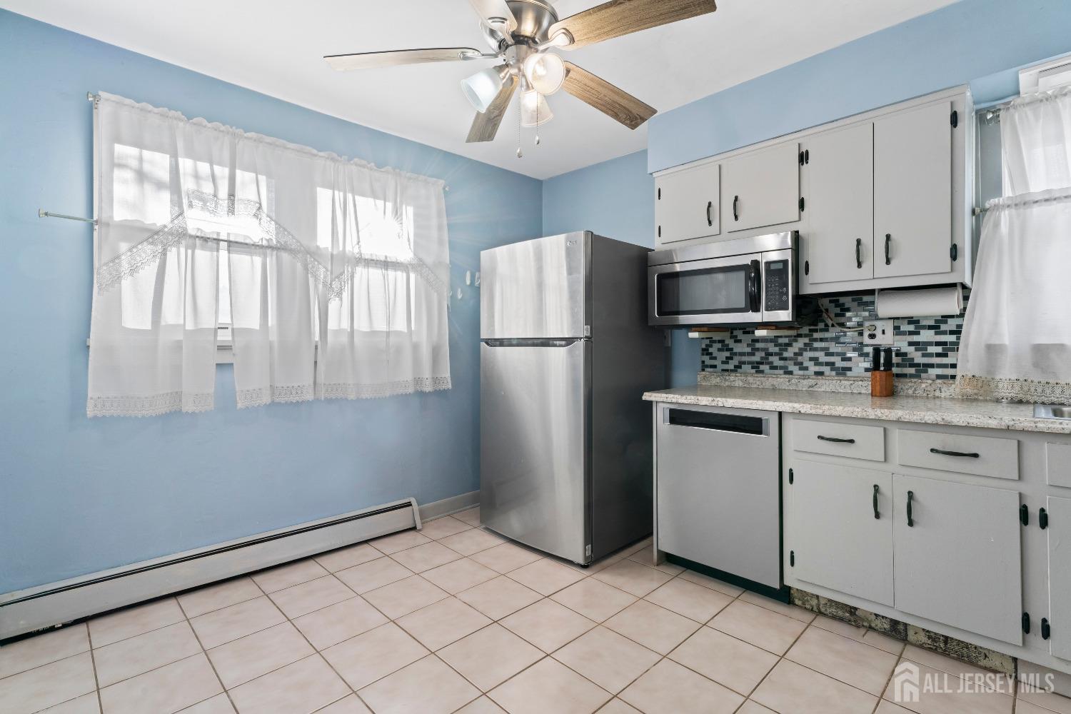 70 Central Avenue Sewaren, NJ 07064 - Photo 15 of 22 a kitchen with white cabinets and refrigerator