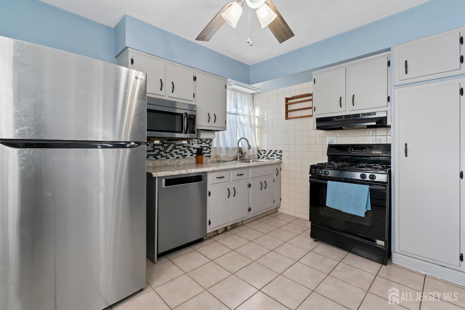 70 Central Avenue Sewaren, NJ 07064 - Photo 16 of 22 a kitchen with cabinets and white stainless steel appliances