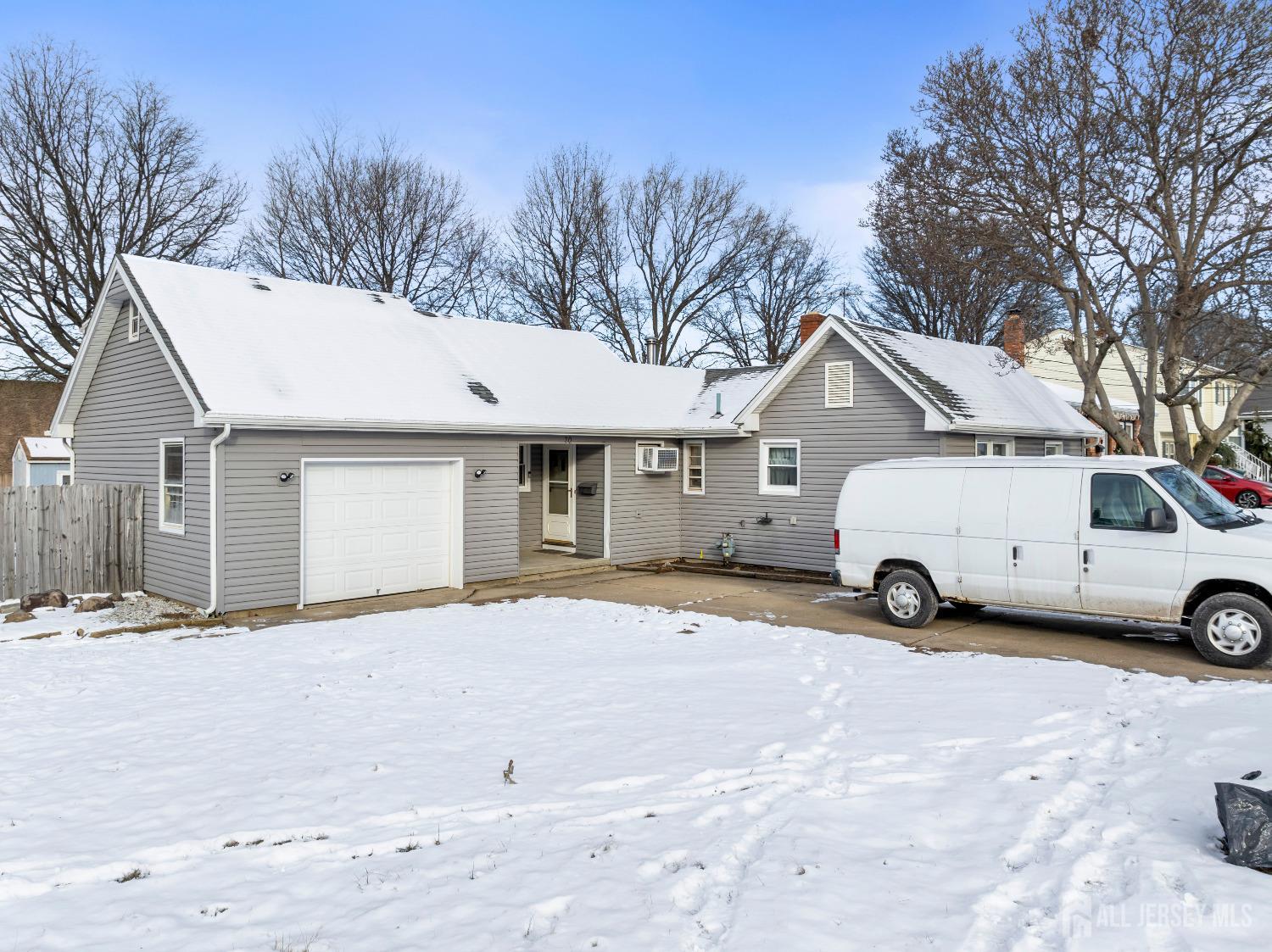70 Central Avenue Sewaren, NJ 07064 - Photo 6 of 22 a view of a white house with a yard covered in snow
