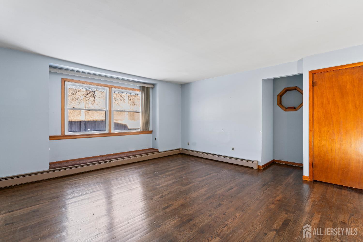 70 Central Avenue Sewaren, NJ 07064 - Photo 10 of 22 an empty room with wooden floor and windows