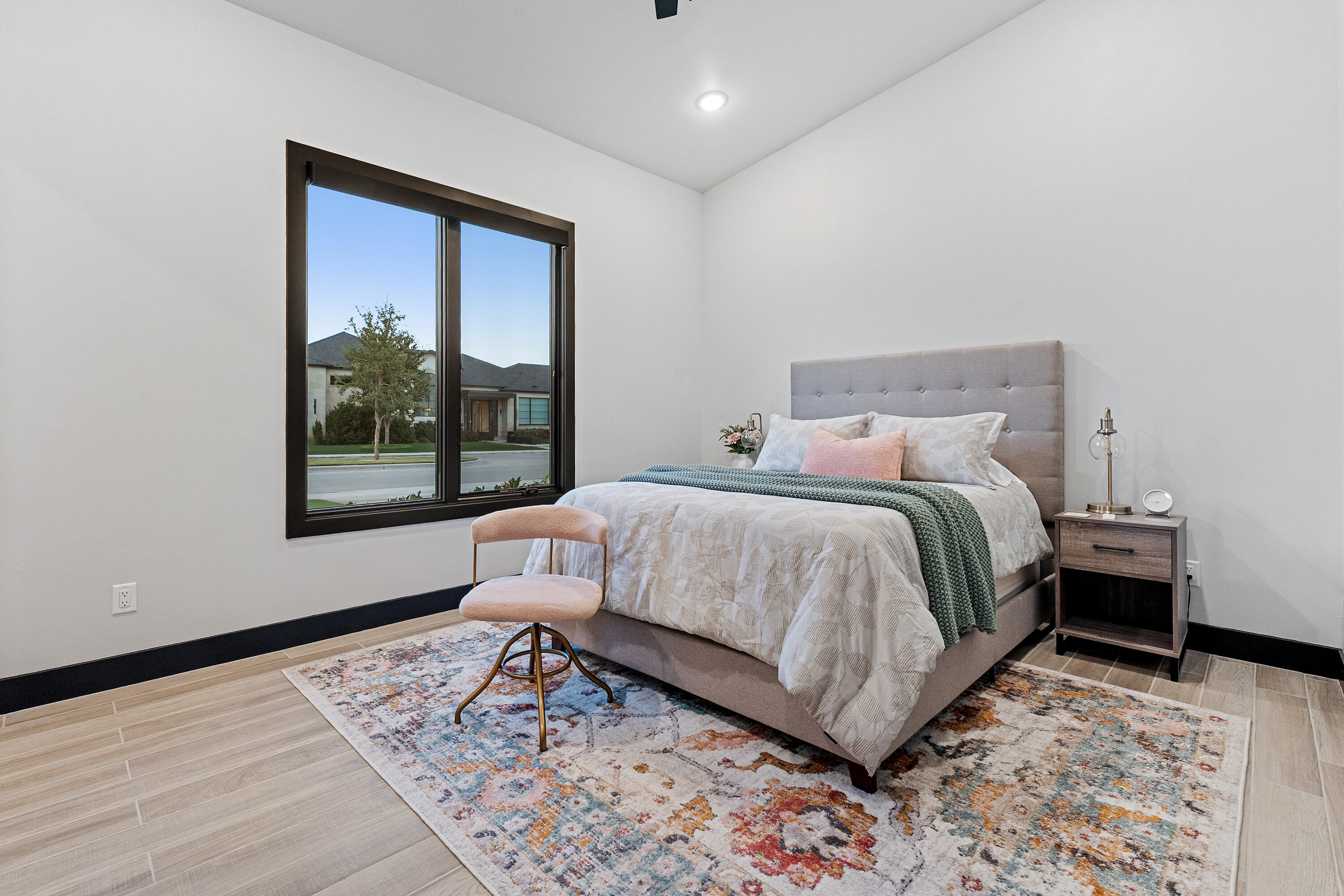 3923 149th Street Lubbock, TX 79423 - Photo 28 of 57 a bedroom with a bed lamp and a large window