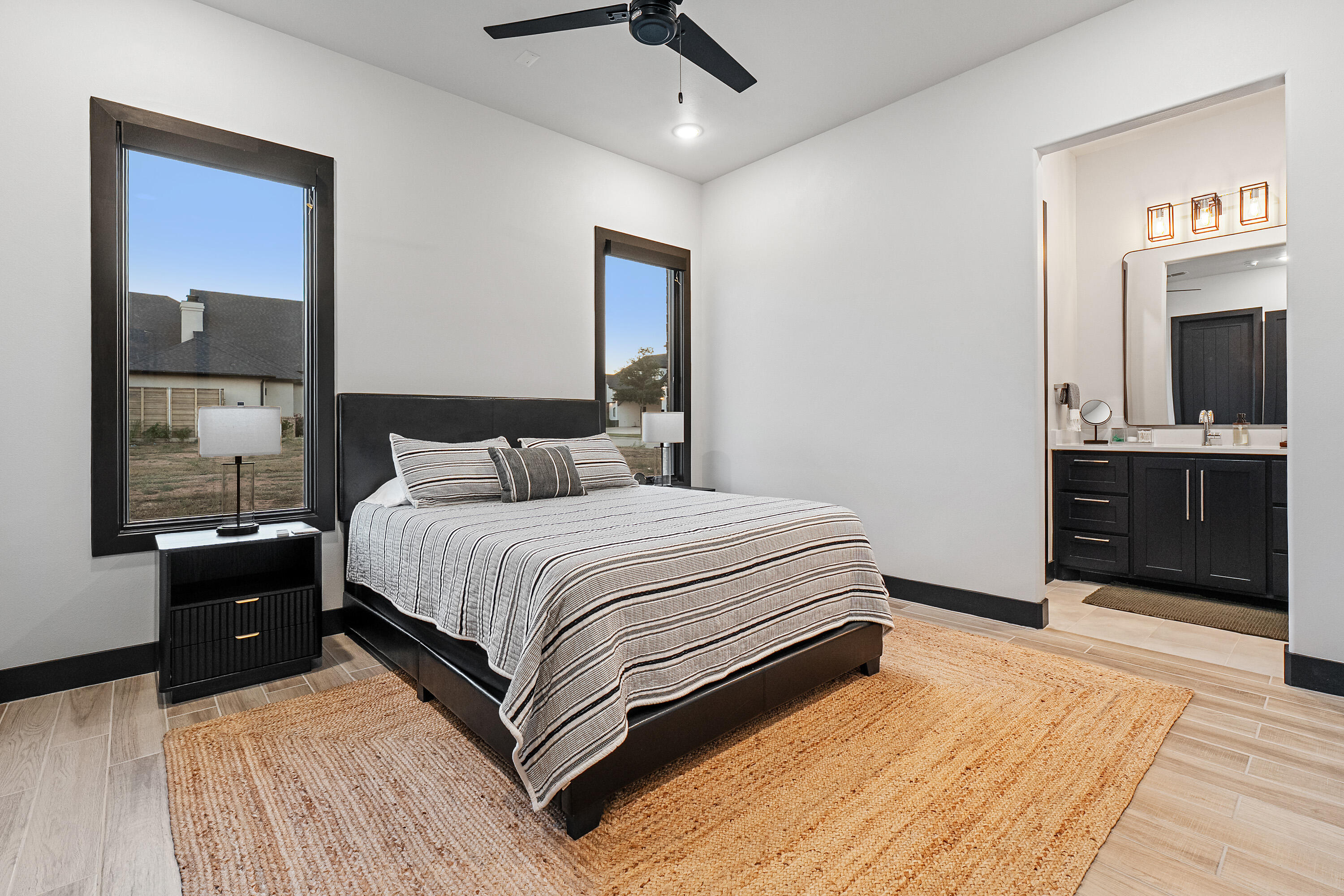 3923 149th Street Lubbock, TX 79423 - Photo 34 of 57 a bedroom with a large bed and a chandelier