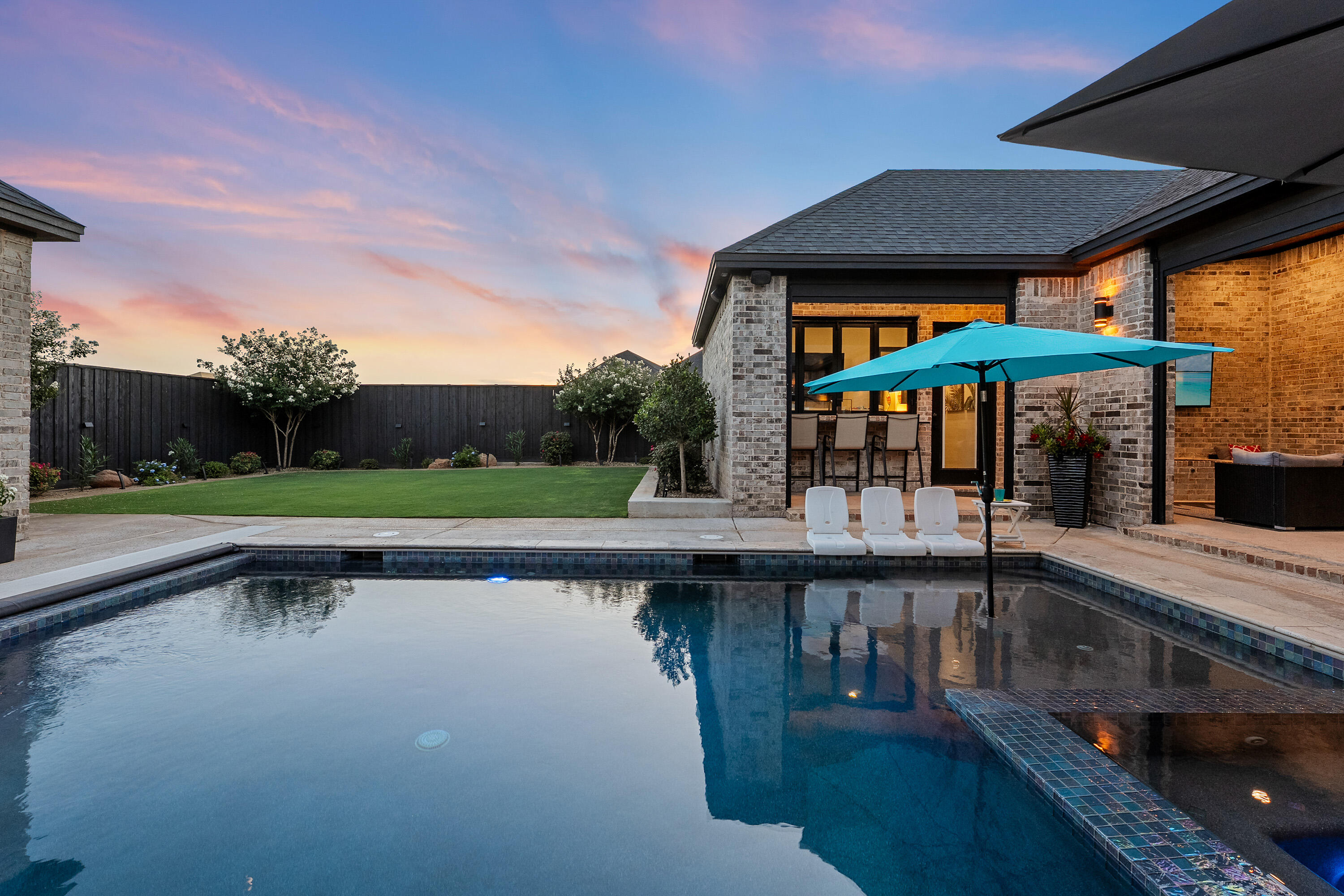 3923 149th Street Lubbock, TX 79423 - Photo 47 of 57 a view of a swimming pool with chairs in patio