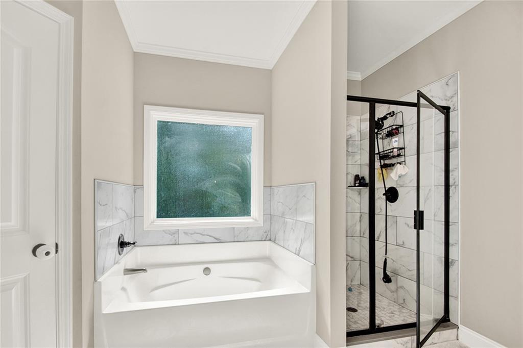 407 Corinth Church Road Winder, GA 30680 - Photo 42 of 66 a bathroom with a bathtub and a shower