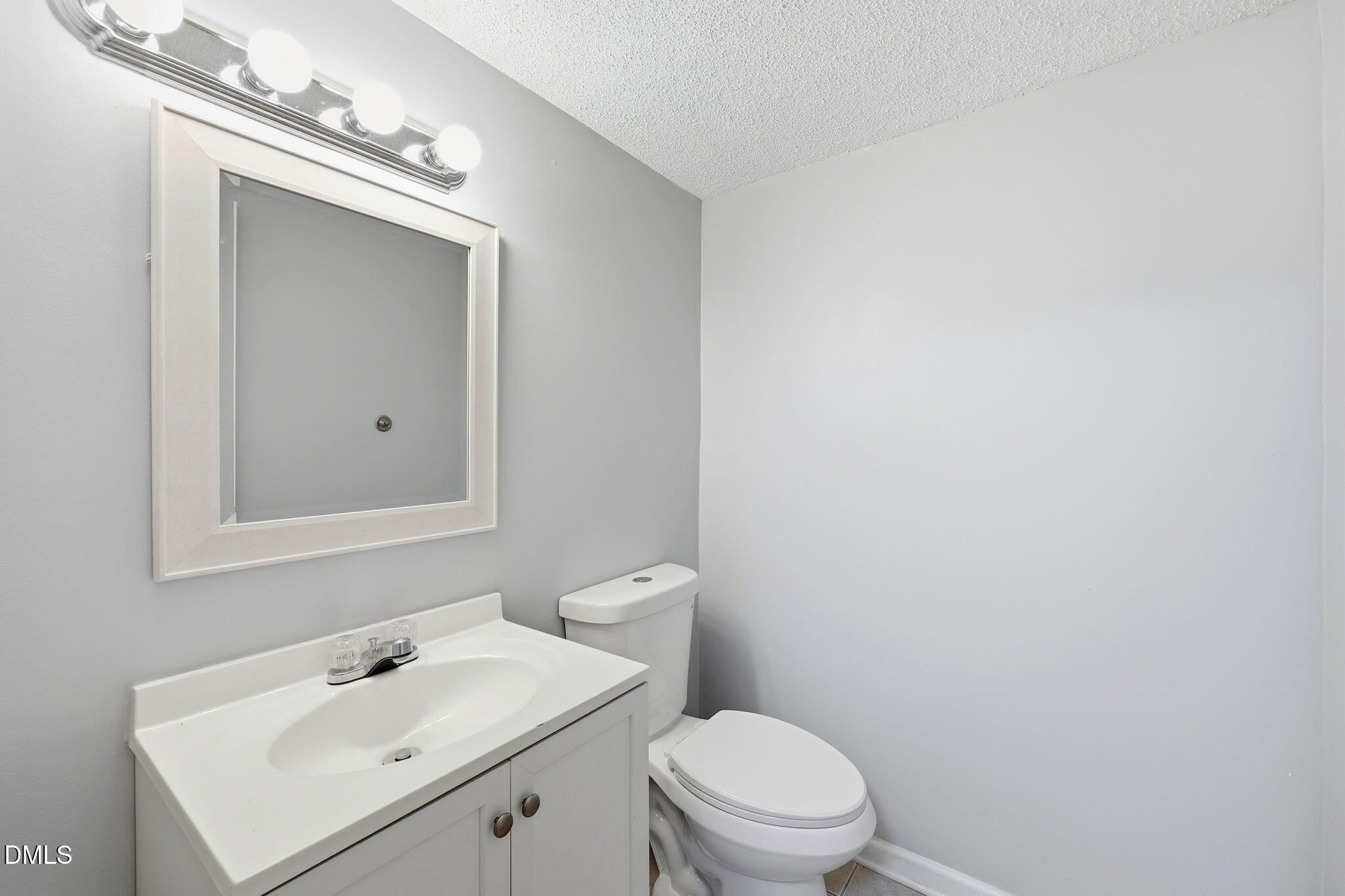 5043 Tall Pines Court Raleigh, NC 27609 - Photo 25 of 37 a bathroom with a sink a toilet and mirror