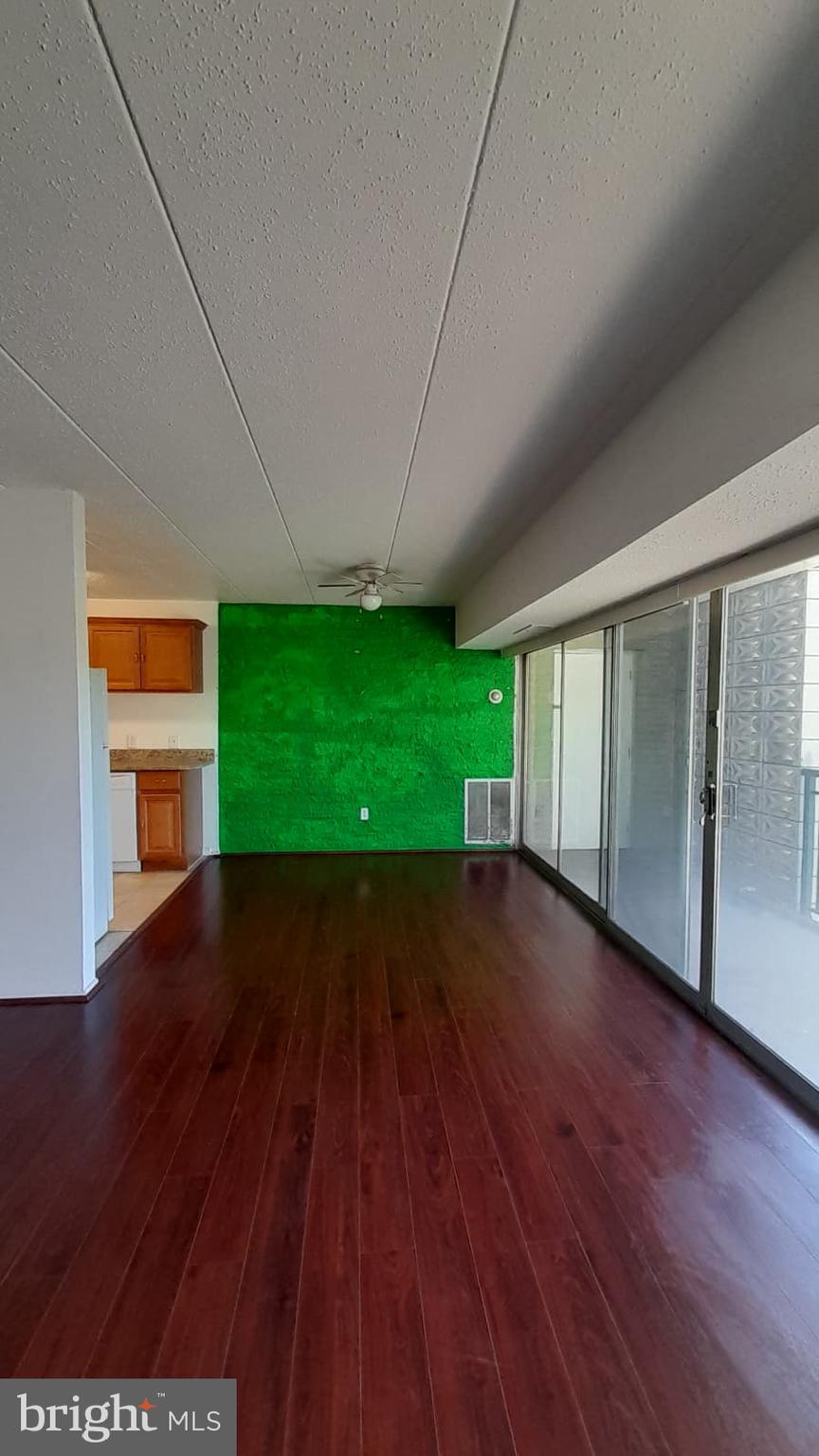 1804 Metzerott Road, Unit 303 Hyattsville, MD 20783 - Photo 5 of 13 a view of empty room with wooden floor and fan