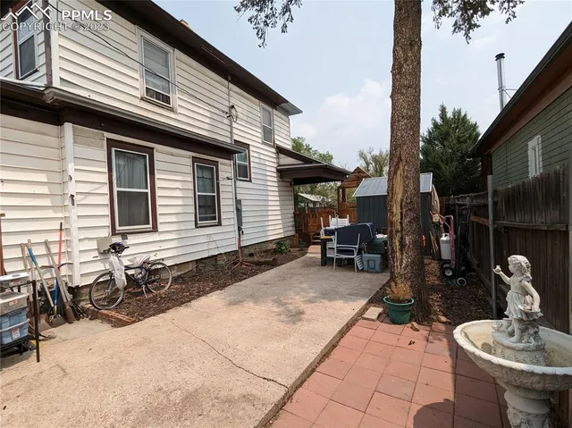 a backyard of a house with yard fire pit and outdoor seating