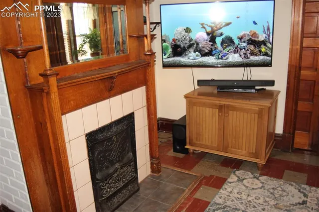 a living room with a fireplace wooden floor and furniture