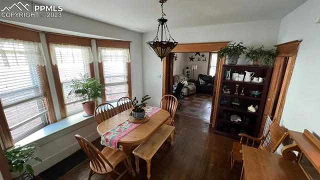 a living room with furniture a window and wooden floor