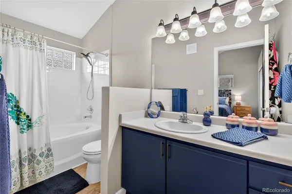 a bathroom with a granite countertop sink mirror and toilet