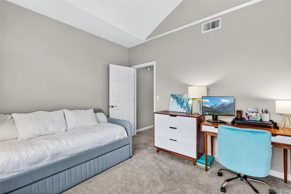 a bedroom with furniture and a dresser