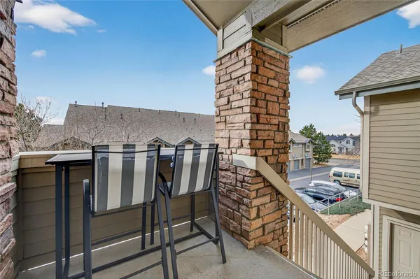 a balcony view with a backyard space