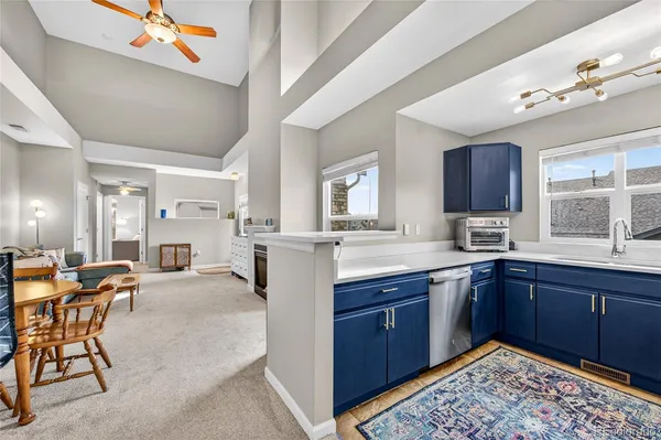 a large kitchen with lots of counter space and dining table