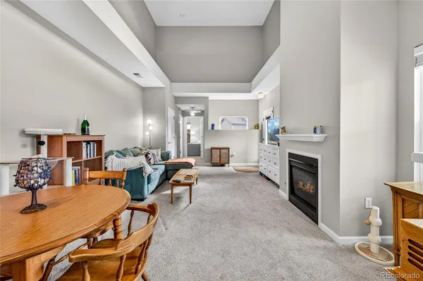 a living room with furniture a fireplace and a table