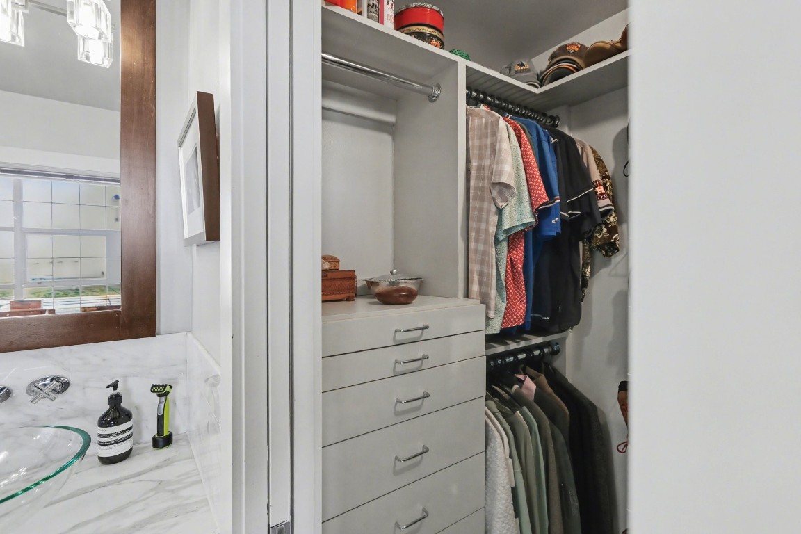 204 Travis Street, Unit 4E Houston, TX 77002 - Photo 15 of 29 a view of walk in closet with clothes and shoes