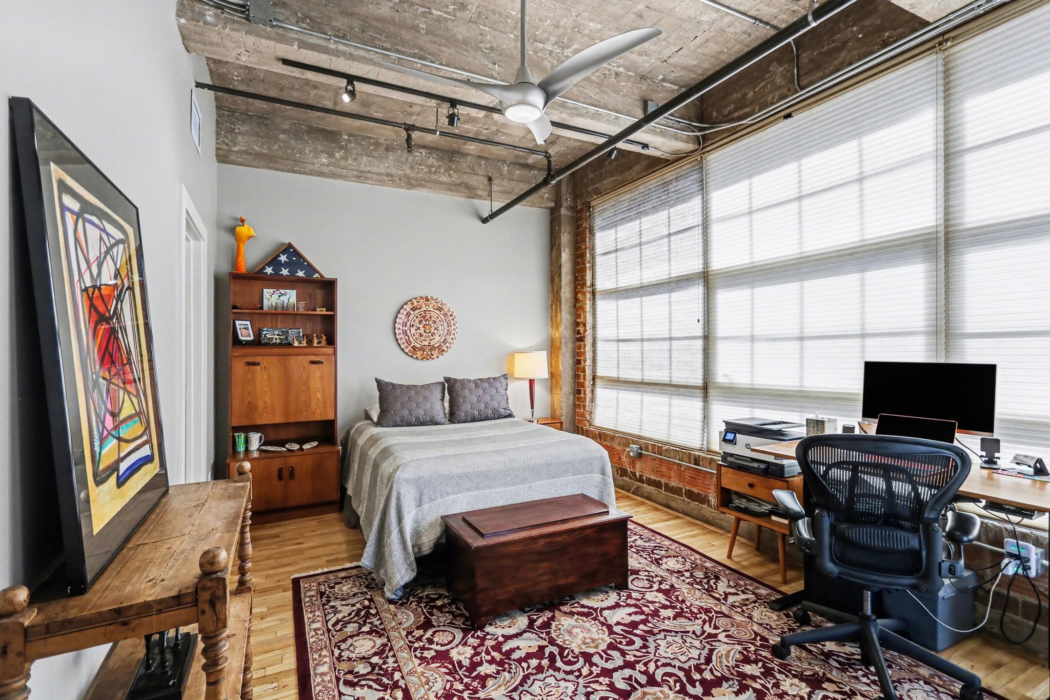 204 Travis Street, Unit 4E Houston, TX 77002 - Photo 16 of 29 a bedroom with a bed window and a flat screen tv