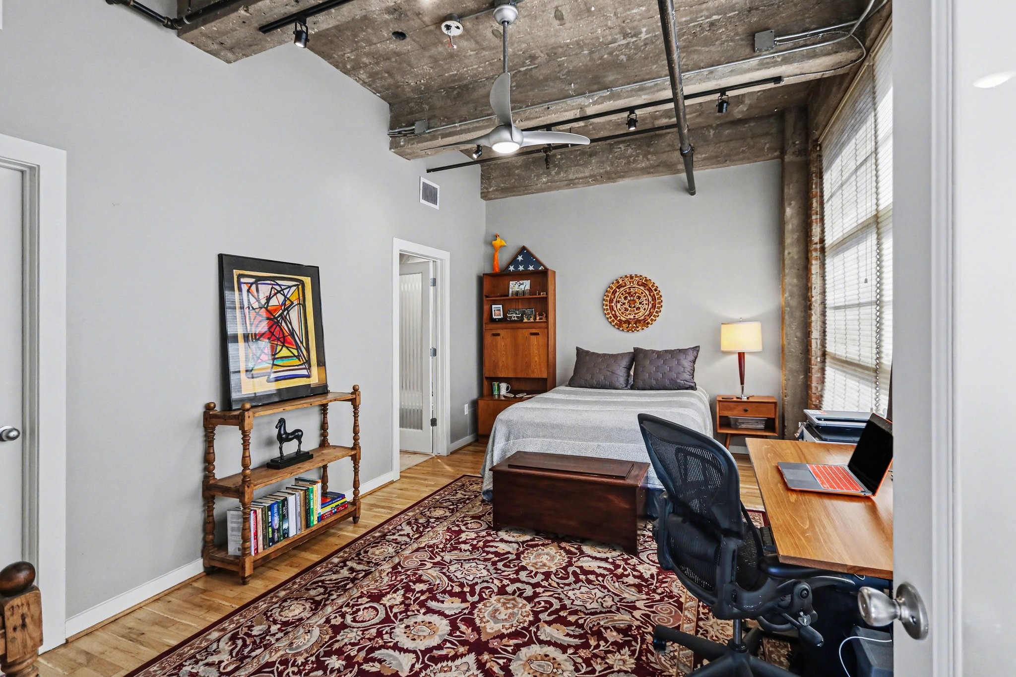 204 Travis Street, Unit 4E Houston, TX 77002 - Photo 17 of 29 a view of a workspace with furniture and a window