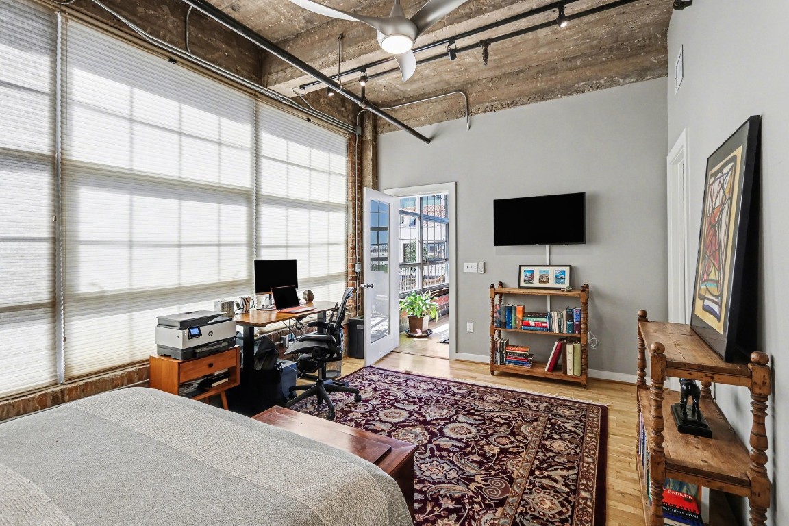 204 Travis Street, Unit 4E Houston, TX 77002 - Photo 18 of 29 a bedroom with a flat screen tv and a window