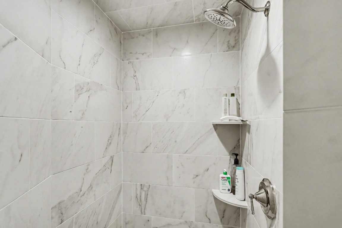 204 Travis Street, Unit 4E Houston, TX 77002 - Photo 20 of 29 a bathroom with a shower and toilet