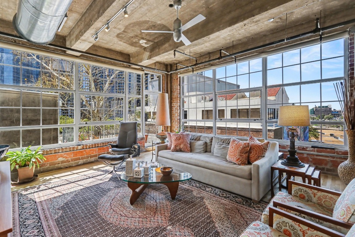 204 Travis Street, Unit 4E Houston, TX 77002 - Photo 2 of 29 a living room with patio furniture and a potted plant