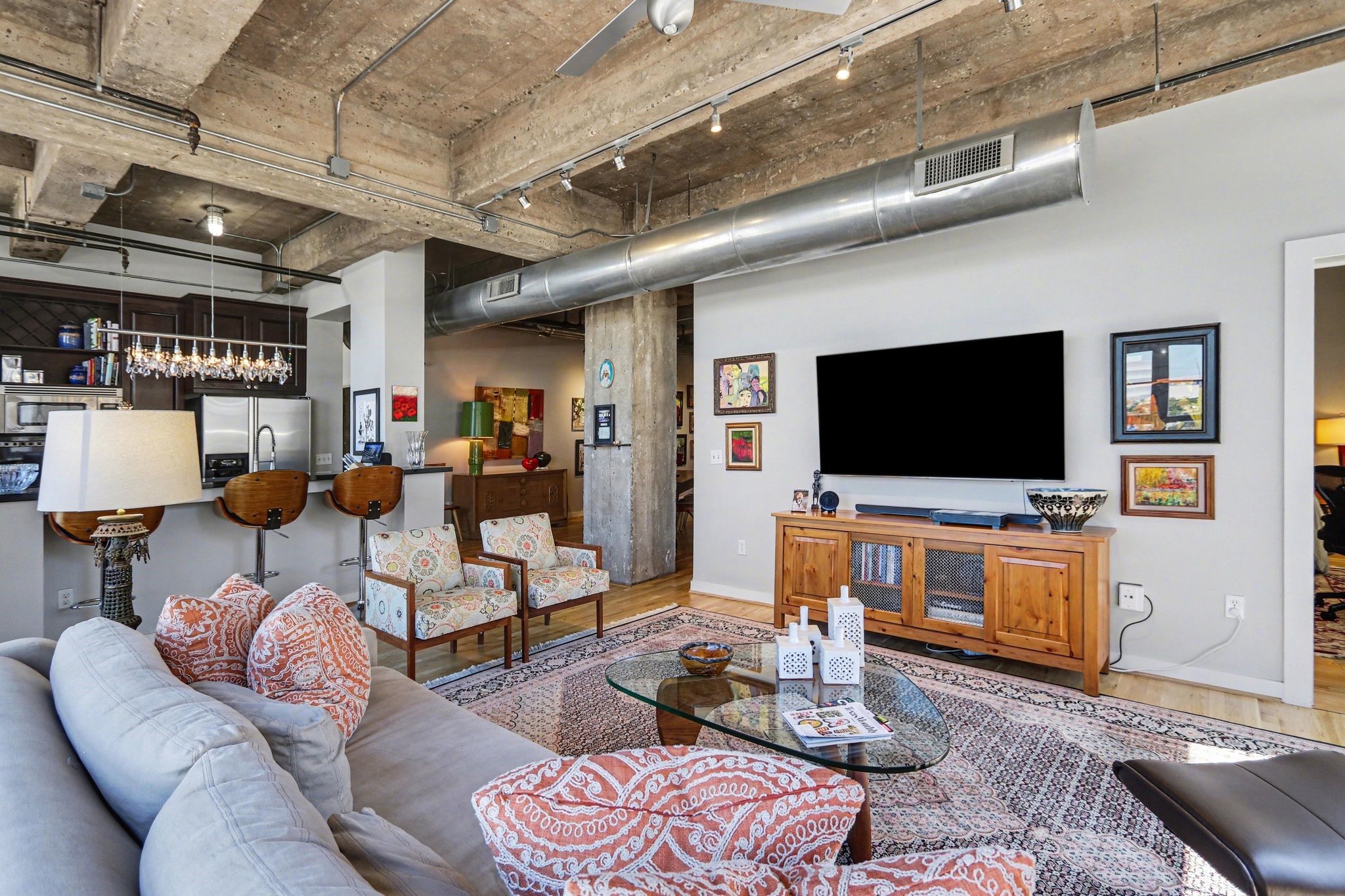 204 Travis Street, Unit 4E Houston, TX 77002 - Photo 6 of 29 a living room with furniture and a flat screen tv