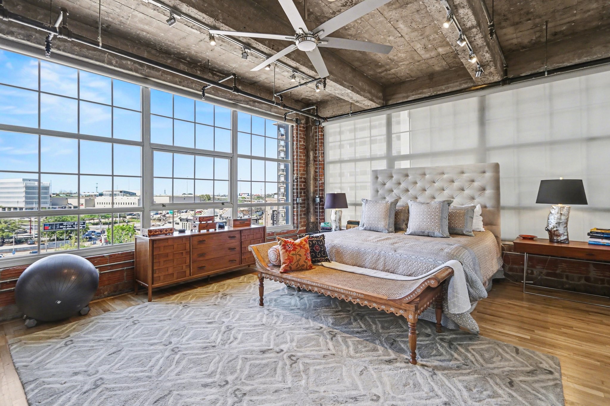 204 Travis Street, Unit 4E Houston, TX 77002 - Photo 10 of 29 a bedroom with furniture and a large window