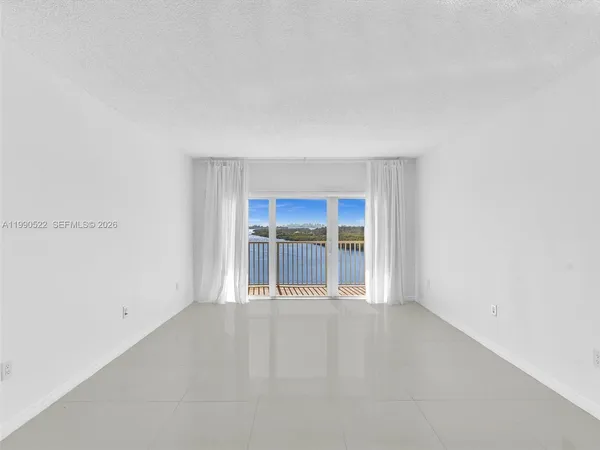 a kitchen with stainless steel appliances white cabinets and a refrigerator