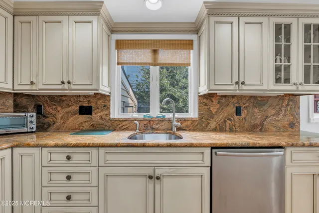 a kitchen with a dining table chairs and window