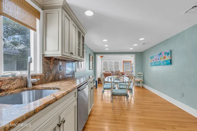 a kitchen with cabinets stainless steel appliances and a sink