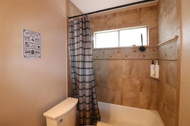 a bathroom with a shower toilet and sink