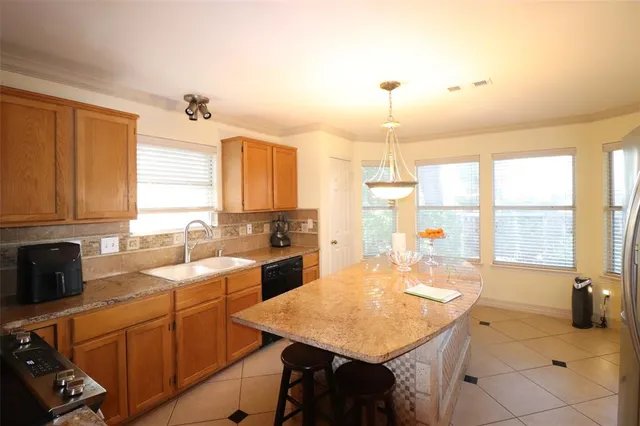 a kitchen with a sink appliances and cabinets