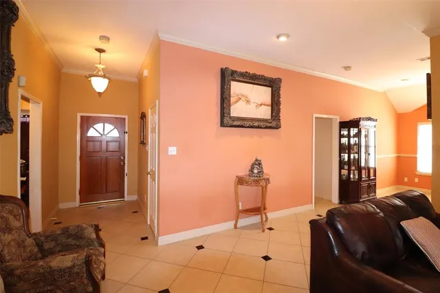 a living room with furniture a window and a flat screen tv
