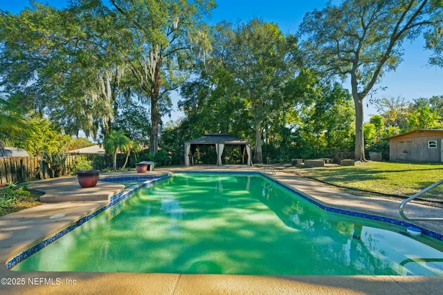 a view of a swimming pool with a yard