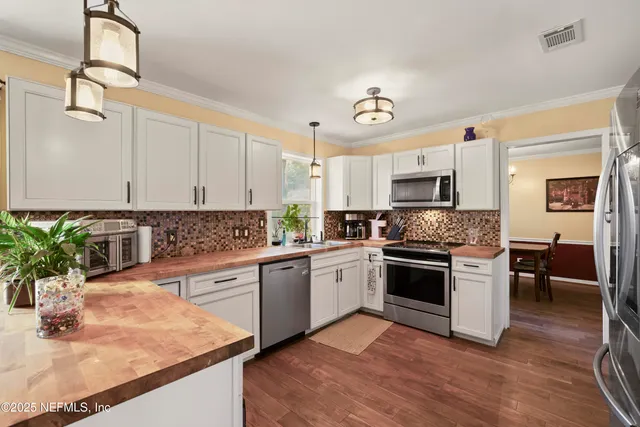 a bedroom with a bed and a flat tv screen on a dresser