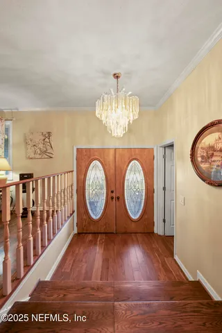 a view of a porch with a floor to ceiling window and tree