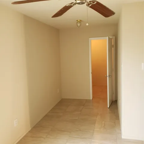 an empty room with a ceiling fan