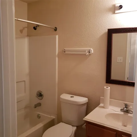 a bathroom with a sink a mirror and a toilet