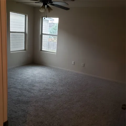 an empty room with windows and closet