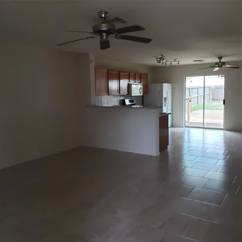 a view of a livingroom with a ceiling fan and window