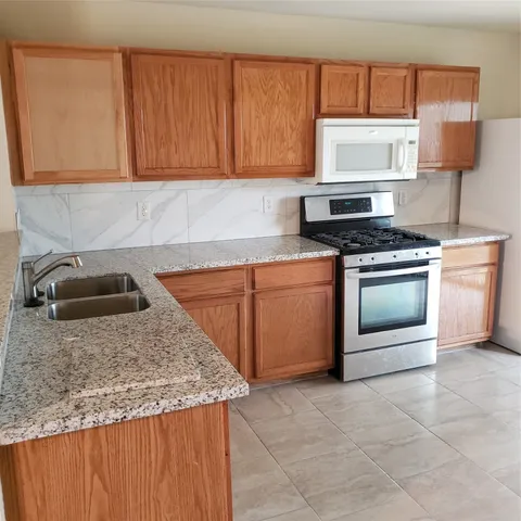 a kitchen with a stove and a sink