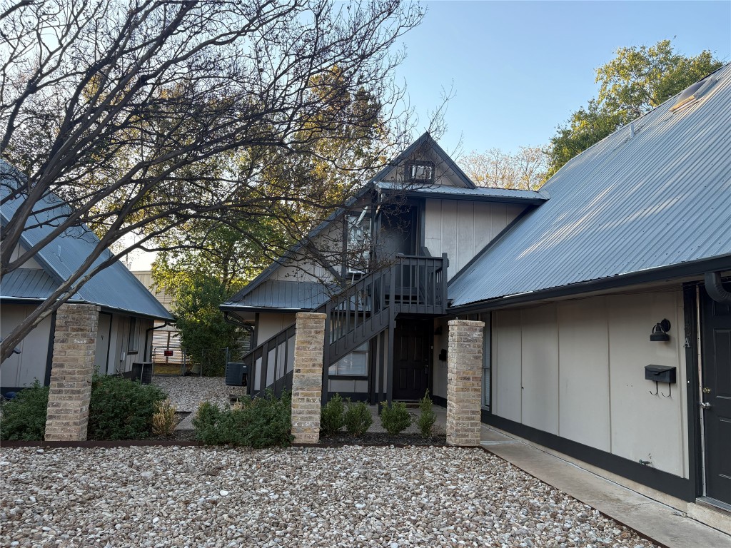 8612 Bowling Green Drive, Unit B Austin, TX 78757 - Photo 1 of 1 View of front facade featuring board and batten siding, a metal roof, and stairs