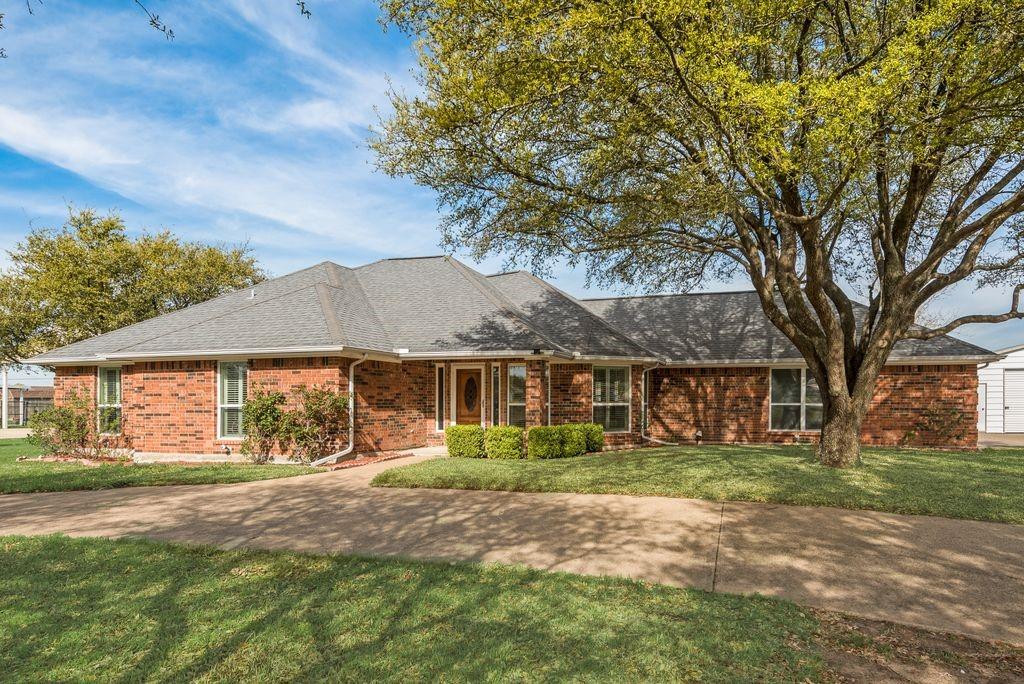 11374 Jennifer Circle Forney, TX 75126 - Photo 1 of 36 Charming ranch style home with a beautiful manicured lawn, mature trees, and a convenient circle drive that adds both curve appeal and functionality.