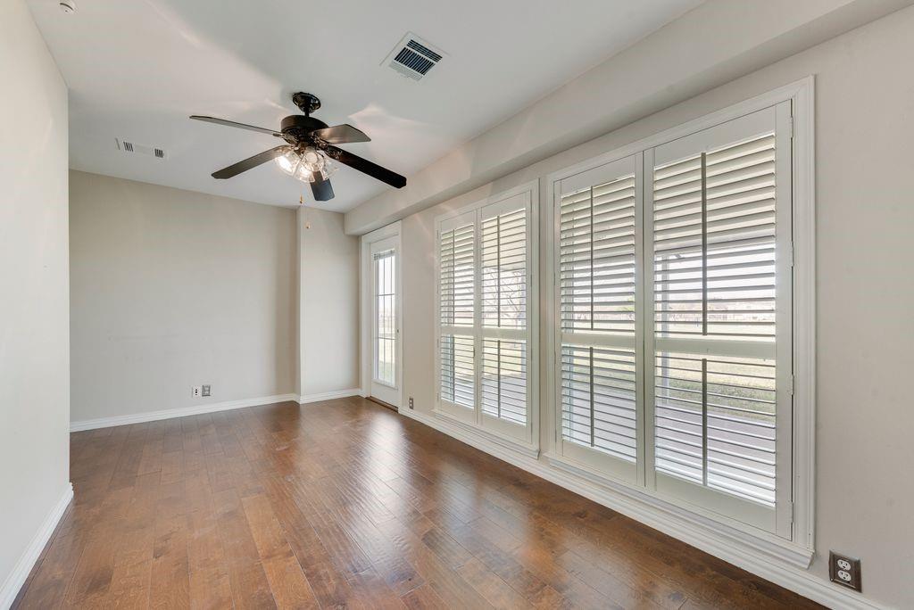 11374 Jennifer Circle Forney, TX 75126 - Photo 21 of 36 Office area featuring dark wood flooring and a ceiling fan that goes out to an outdoor patio.