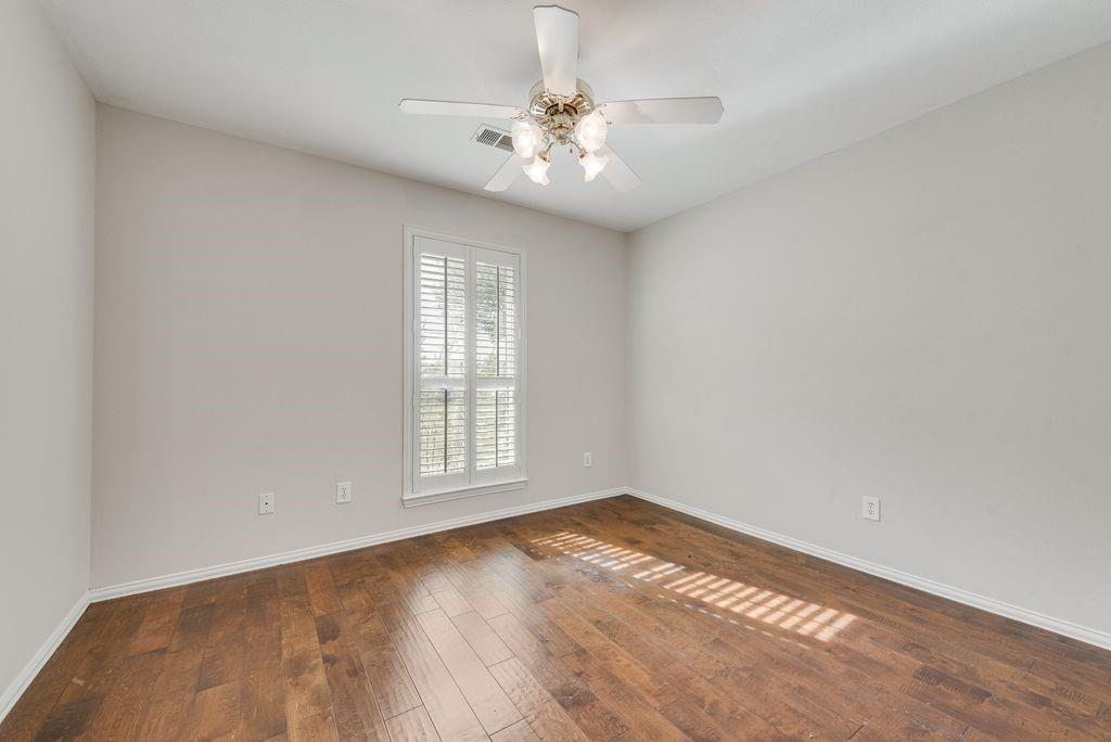 11374 Jennifer Circle Forney, TX 75126 - Photo 25 of 36 Bedroom with dark wood-style flooring, a ceiling fan and walk in closet.
