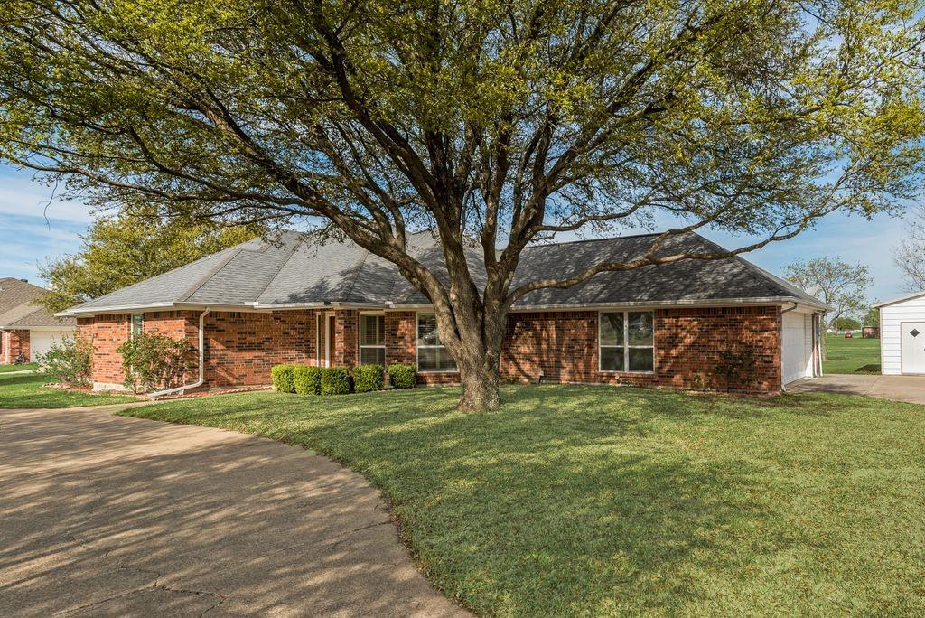 11374 Jennifer Circle Forney, TX 75126 - Photo 4 of 36 View of front of brick ranch style home featuring the front yard, driveway, and an attached garage.
